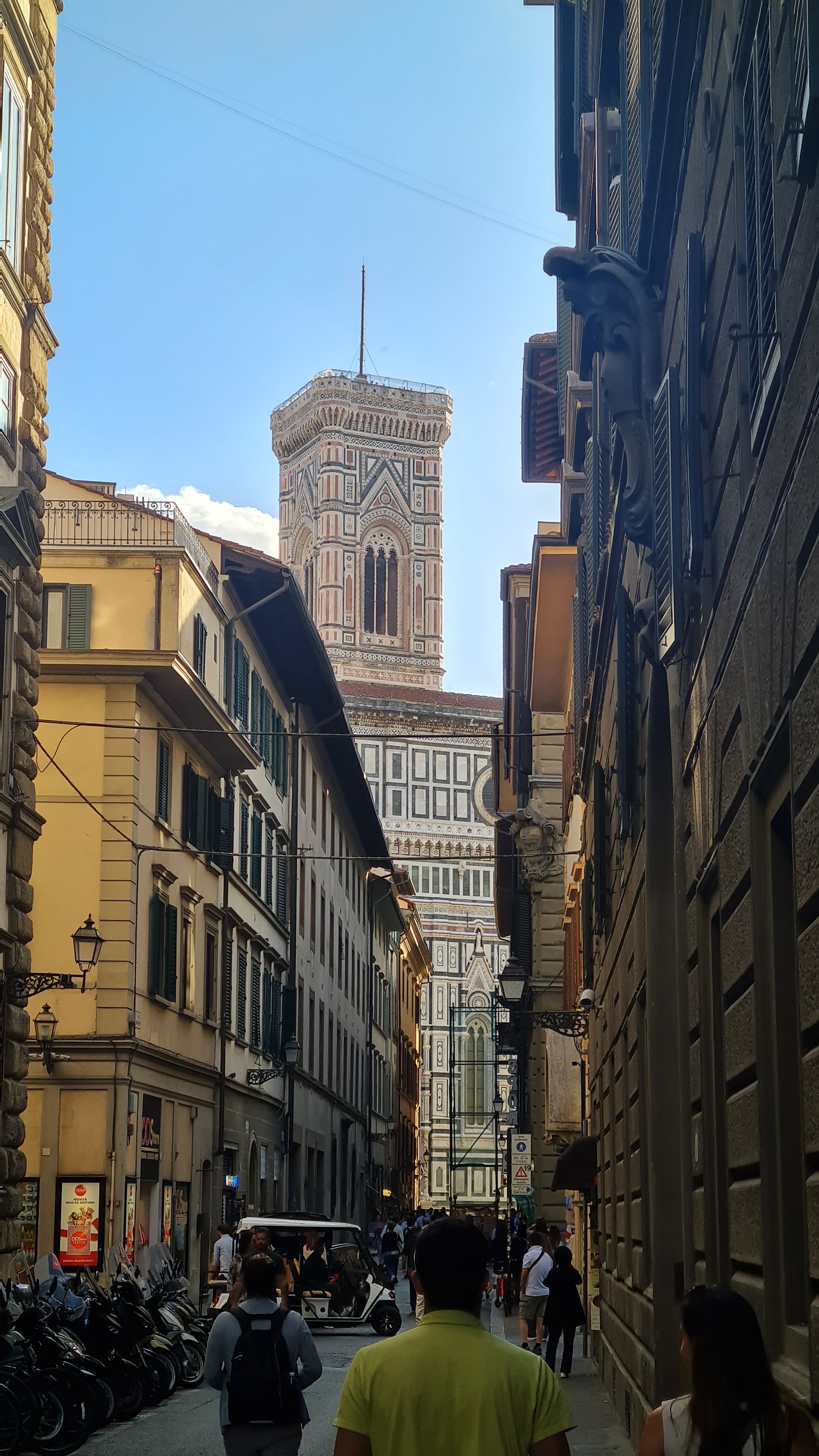 Giotto's Bell Tower rising above a narrow street near the Duomo, Florence