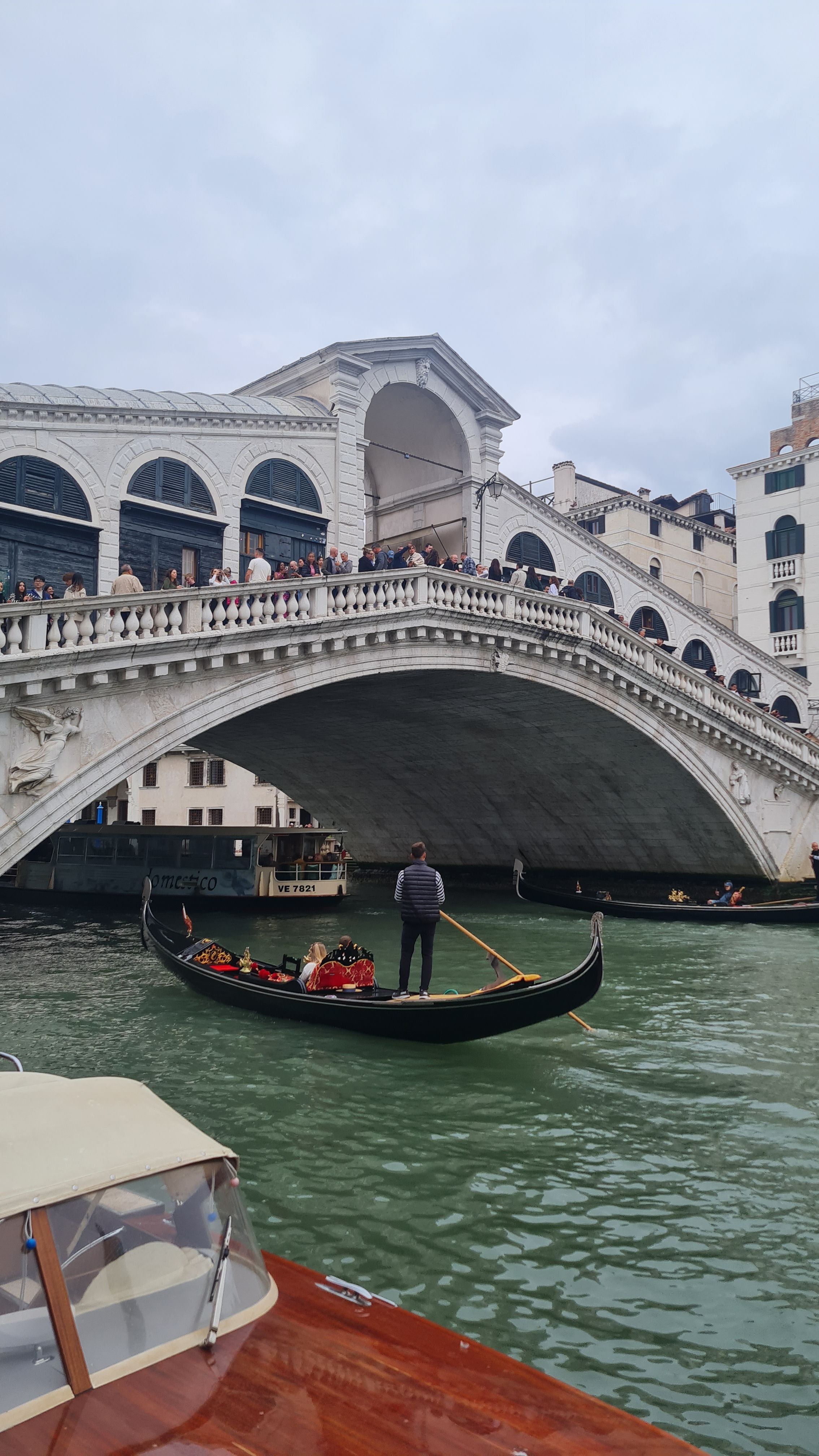 A gondola passing under the Rialto Bridge on the Grand Canal, Venice