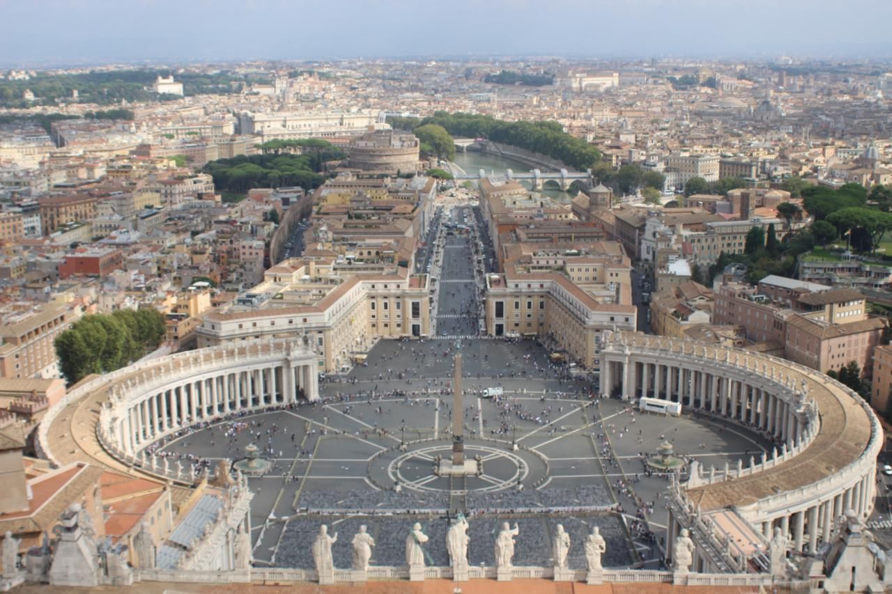 St. Peter's Square and its colonnades seen from the top of the dome, with the city of Rome beyond